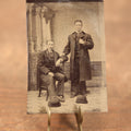 Lot 096 - Single Tintype Photo, Two Men, One Sitting One Standing, With Bowler Hats On The Floor