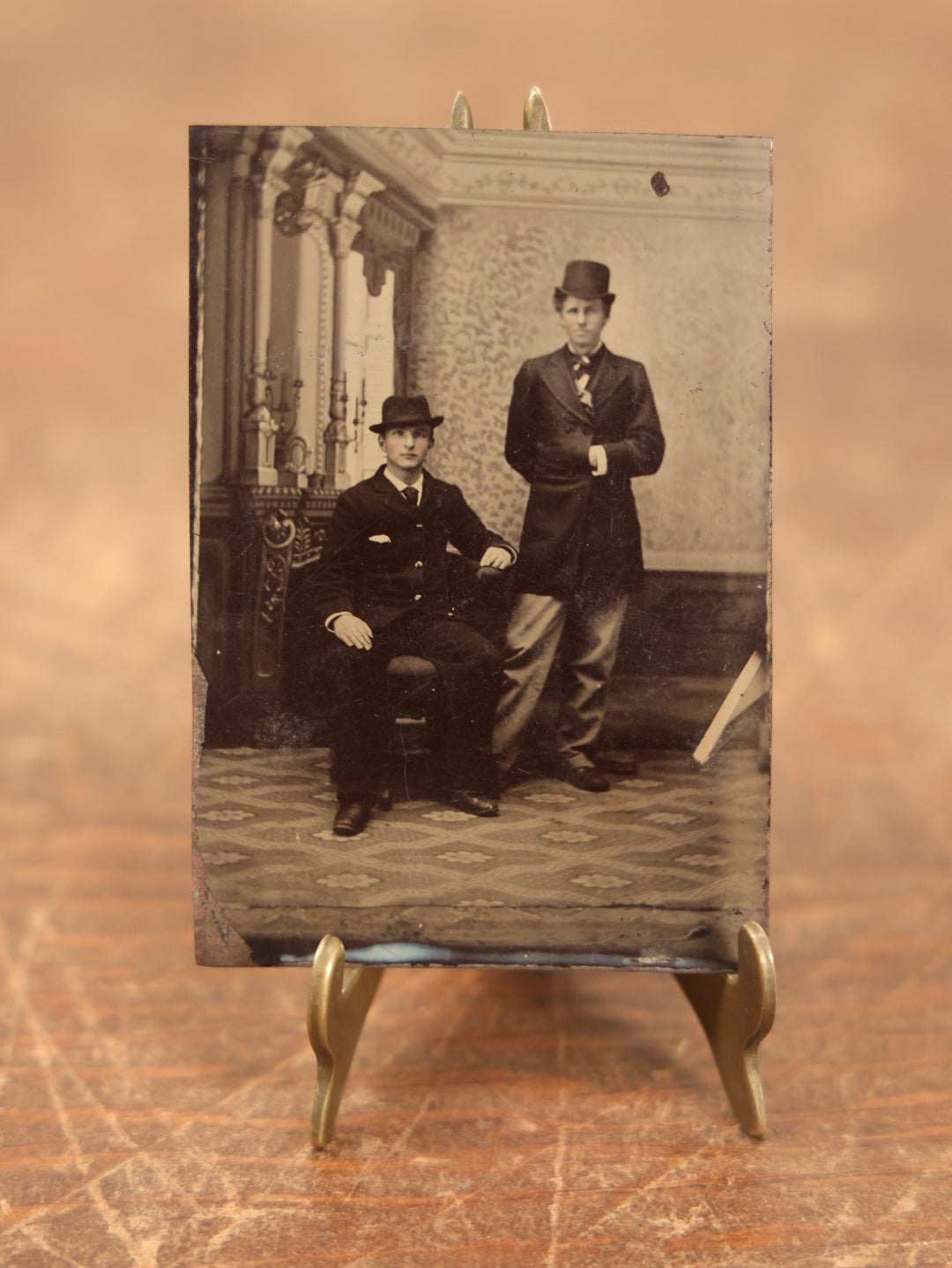 Lot 097 - Single Tintype Photo, Two Men, One Standing, One Sitting, In Hats, Man Has Hand In Coat