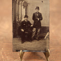 Lot 097 - Single Tintype Photo, Two Men, One Standing, One Sitting, In Hats, Man Has Hand In Coat