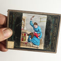 Lot 046 - Antique Hand Colored Magic Lantern Slide, Boy Receiving Spanking From Mother, Note Heavy Damage And Cracking, Theo J. Harbach Manufacturer, Philadelphia, Pennsylvania