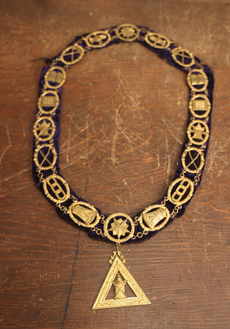 Lot 053 - Antique Odd Fellows I.O.O.F. Purple Chain Collar With Many Symbols Including Three Links And Heart In Hand, With Flaming Pedestal, Crossed Staffs Medallion By Harding Uniform & Regalia Company, Boston