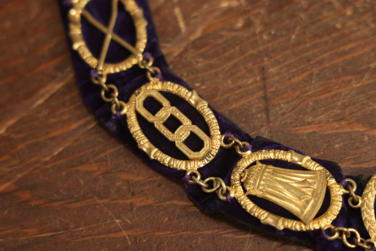 Lot 053 - Antique Odd Fellows I.O.O.F. Purple Chain Collar With Many Symbols Including Three Links And Heart In Hand, With Flaming Pedestal, Crossed Staffs Medallion By Harding Uniform & Regalia Company, Boston