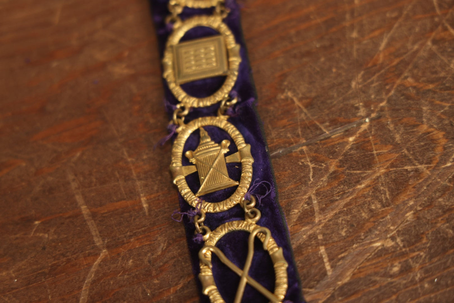 Lot 053 - Antique Odd Fellows I.O.O.F. Purple Chain Collar With Many Symbols Including Three Links And Heart In Hand, With Flaming Pedestal, Crossed Staffs Medallion By Harding Uniform & Regalia Company, Boston