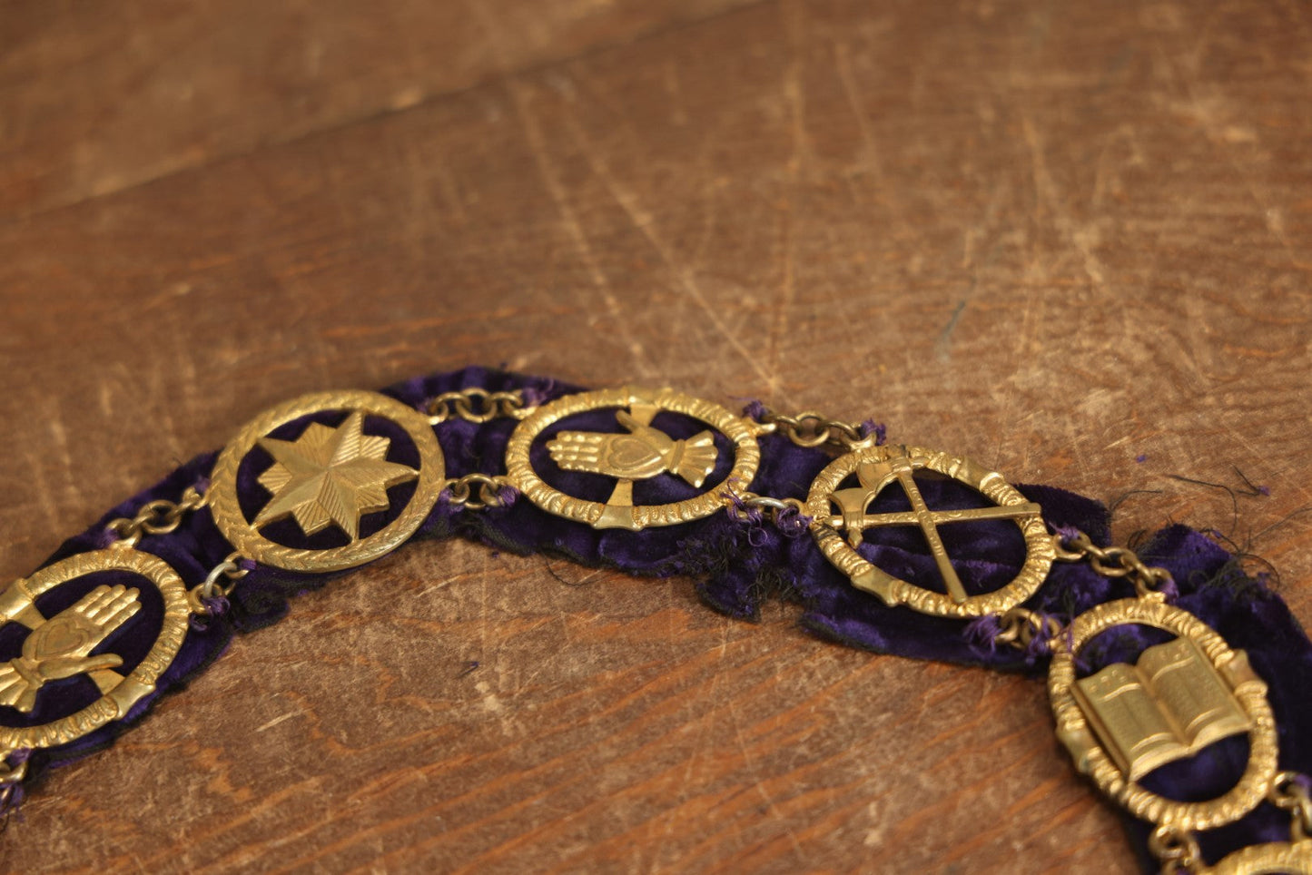 Lot 053 - Antique Odd Fellows I.O.O.F. Purple Chain Collar With Many Symbols Including Three Links And Heart In Hand, With Flaming Pedestal, Crossed Staffs Medallion By Harding Uniform & Regalia Company, Boston