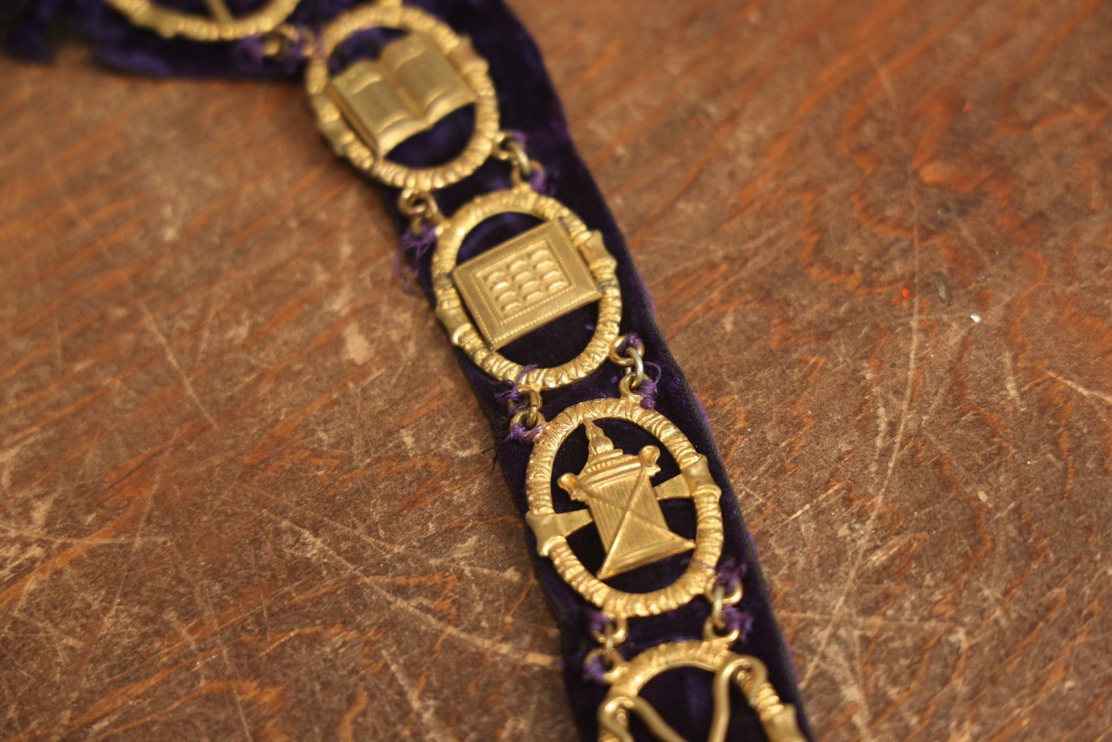 Lot 053 - Antique Odd Fellows I.O.O.F. Purple Chain Collar With Many Symbols Including Three Links And Heart In Hand, With Flaming Pedestal, Crossed Staffs Medallion By Harding Uniform & Regalia Company, Boston