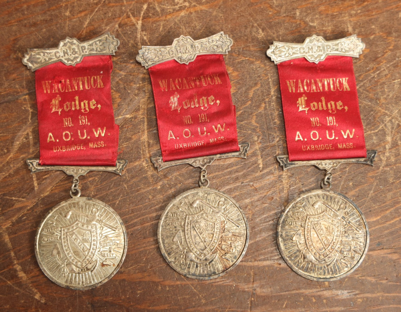 Lot 061 - Grouping Of Three Antique Ancient Order Of United Workmen A.O.U.M. Ribbons And Medallions, Wacantuck Lodge No 191, Uxbridge, Massachusetts, C.H.P., By The Boston Regalia Company