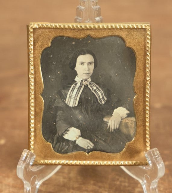 Lot 011 - Antique 1/6th Plate Daguerreotype Of A Young Woman With Short Dark Hair, A Ribbon, Bracelet, And Ring, Under Brass Mat, No Case