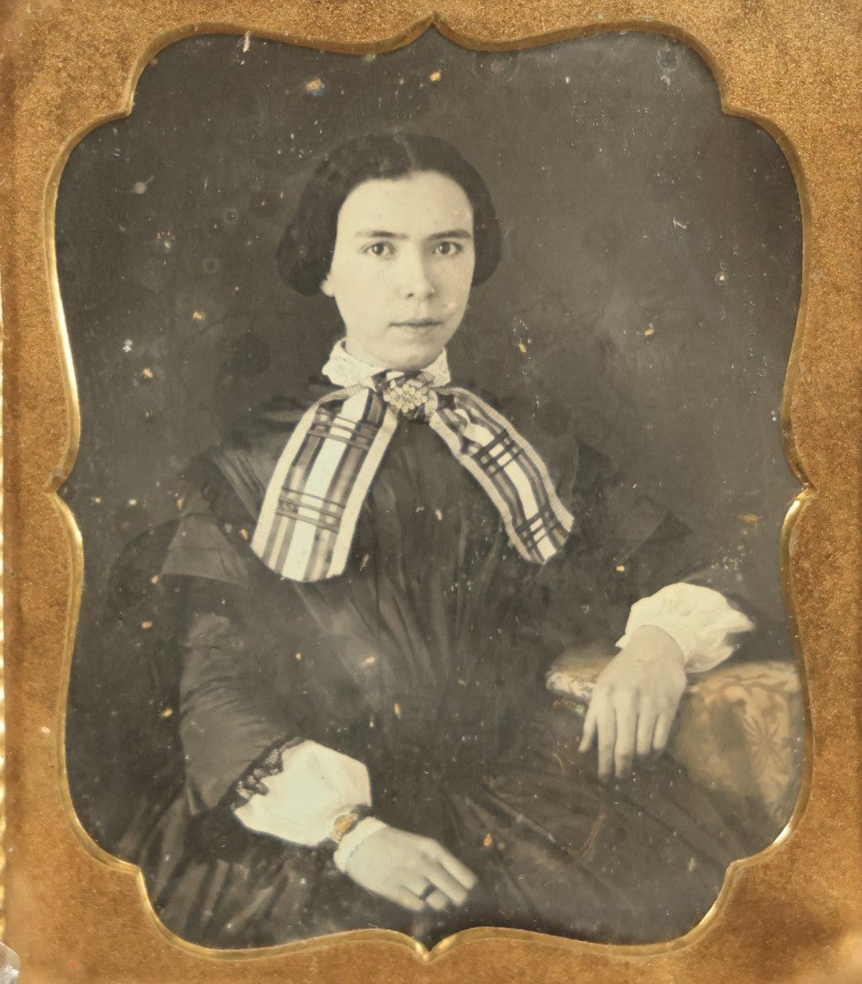 Lot 011 - Antique 1/6th Plate Daguerreotype Of A Young Woman With Short Dark Hair, A Ribbon, Bracelet, And Ring, Under Brass Mat, No Case