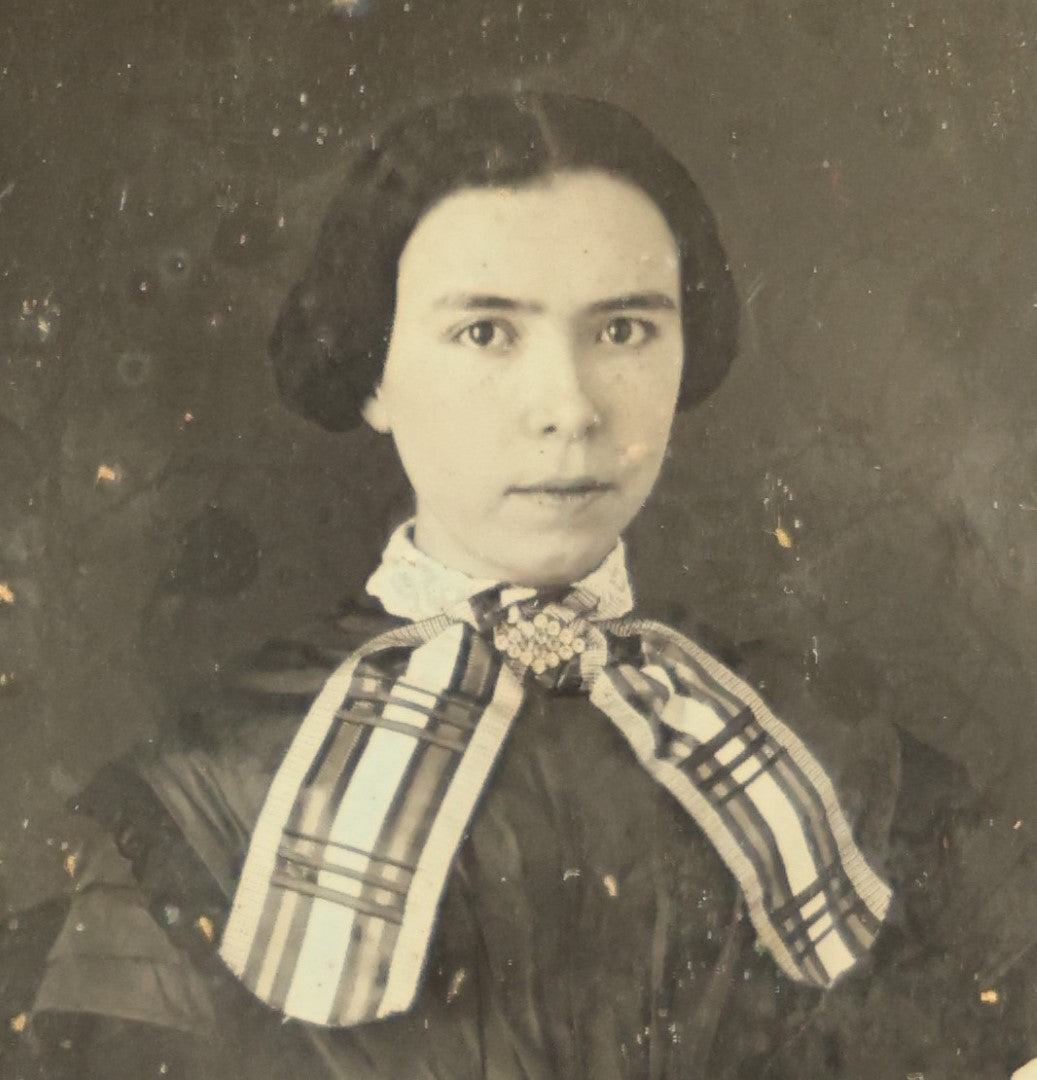 Lot 011 - Antique 1/6th Plate Daguerreotype Of A Young Woman With Short Dark Hair, A Ribbon, Bracelet, And Ring, Under Brass Mat, No Case