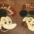 Lot 021 - Pair Of Vintage Folk Art Mickey Mouse And Minnie Mouse Scroll Cut Wood Faces, Hand Painted, With Name Ribbons, Note Mickey Missing Nose