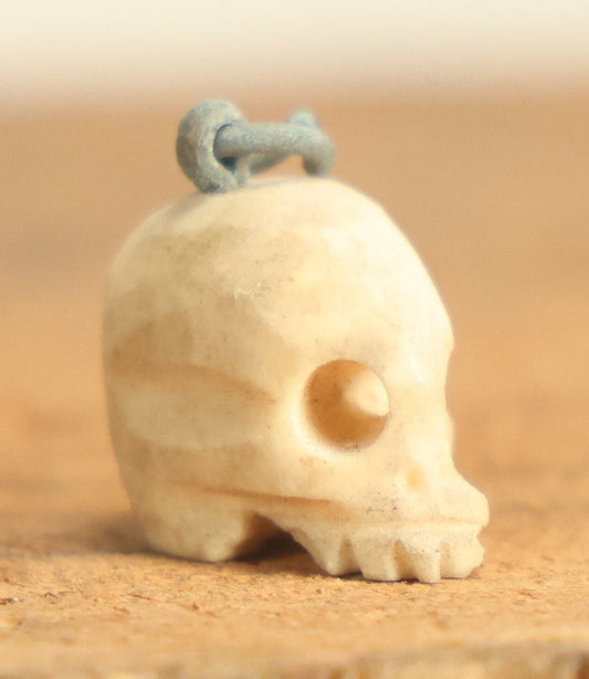 Lot 022 - Vintage Miniature Carved Bone Skull Charm With Hoop