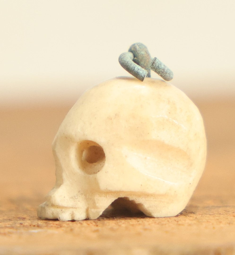 Lot 022 - Vintage Miniature Carved Bone Skull Charm With Hoop