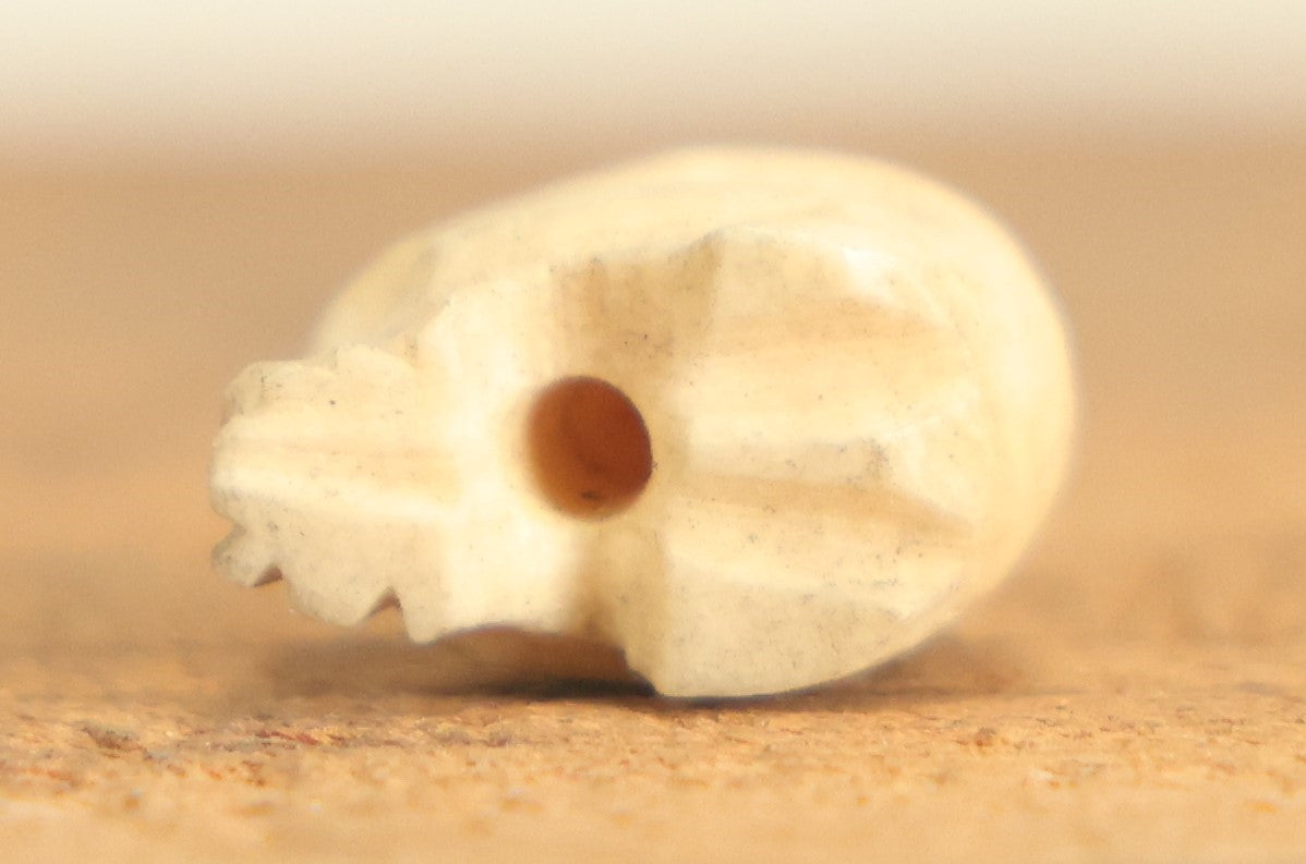 Lot 022 - Vintage Miniature Carved Bone Skull Charm With Hoop