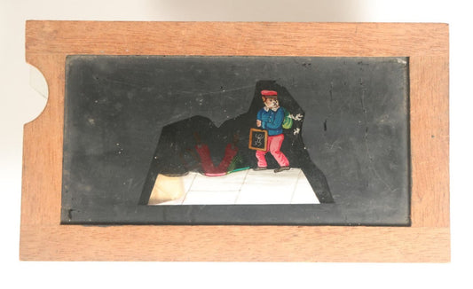 Lot 042 - Antique Hand Painted Animated Magic Lantern Motion Slide, Schoolboy With Chalk Tablet Falls Down Open Manhole