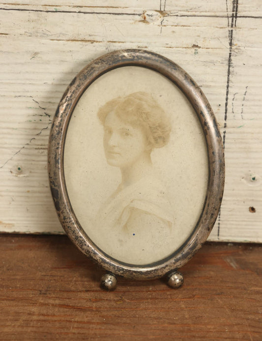 Lot 064 - Antique Photo Of Young Woman In Tarnished Sterling Silver Oval Frame, Missing Kickstand, Marked Sterling