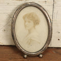 Lot 064 - Antique Photo Of Young Woman In Tarnished Sterling Silver Oval Frame, Missing Kickstand, Marked Sterling