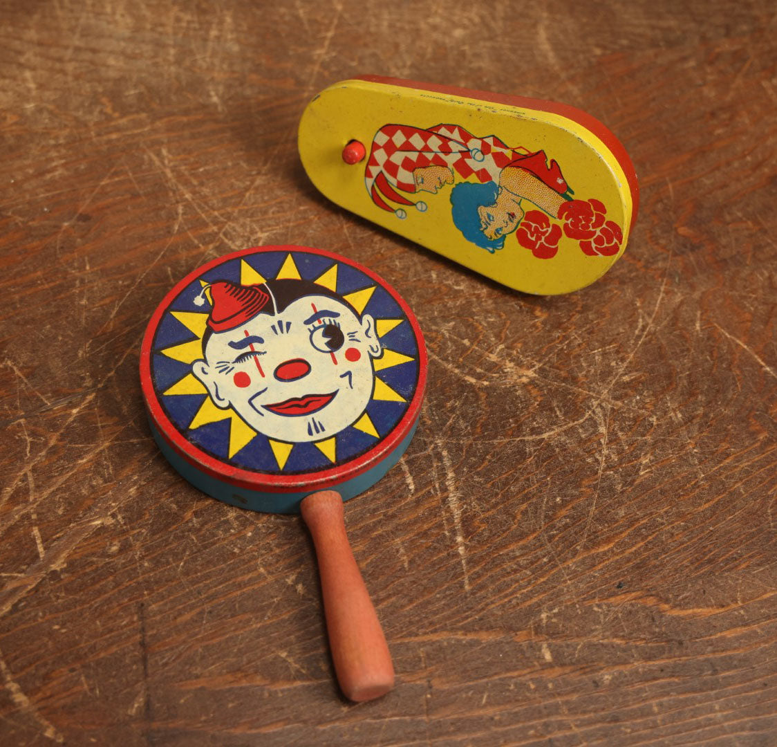 Lot 095 - Pair Of Tin Lithograph Clown Noisemakers, Winking Clown And Harlequin With Woman, By Kirchhof, Newark, New Jersey