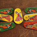 Lot 098 - Grouping Of Seven Spinning Party Noisemakers With Women Dancers, Clowns, And More, By Us Metal Toy Manufacturing Company
