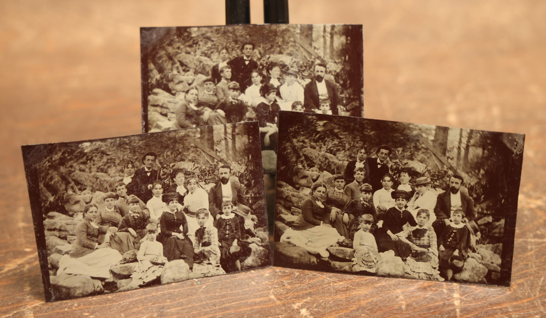 Lot 105 - Grouping Of Three Exterior Tintype Group Photographs With Fourteen People, Same Photo With Different Poses