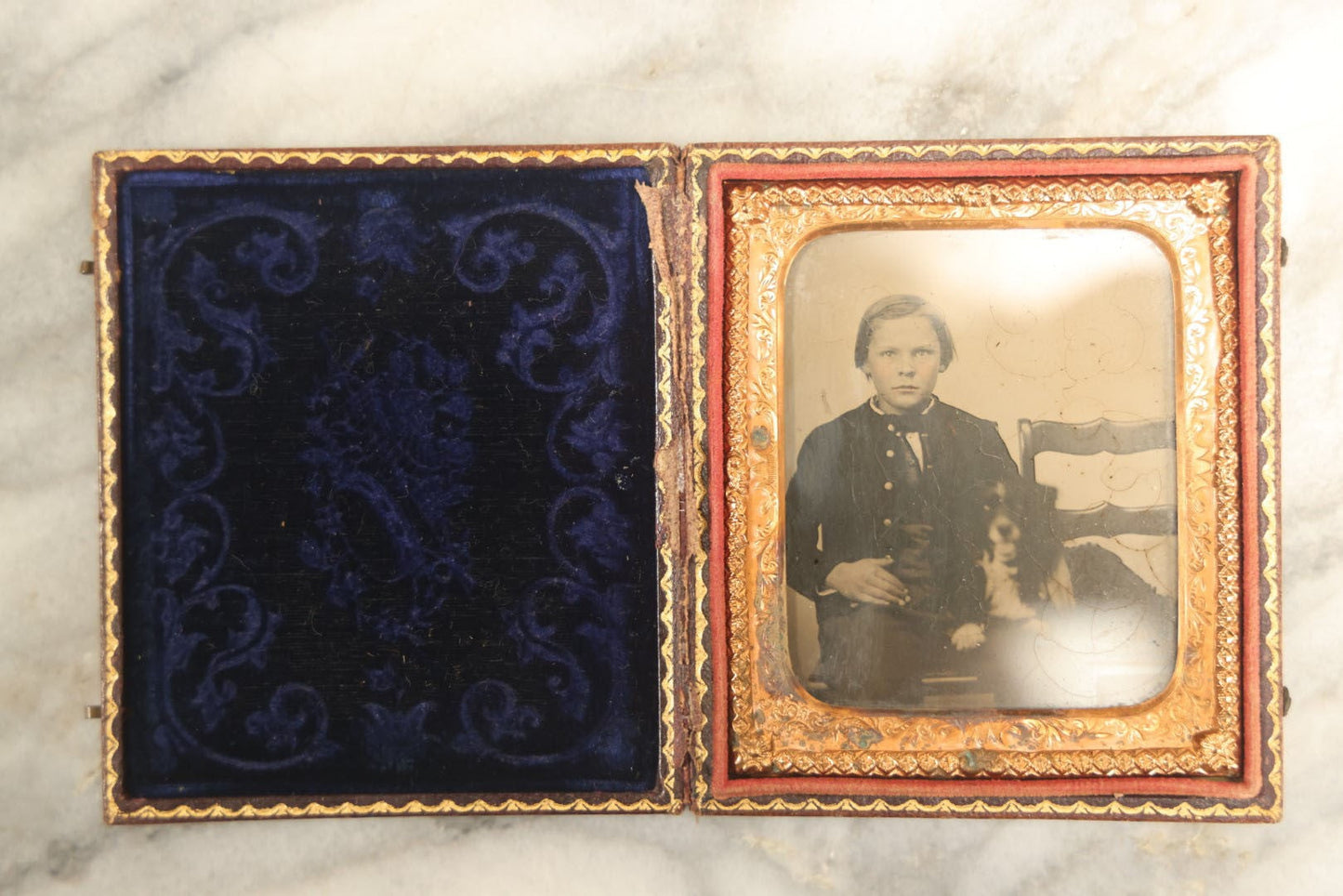 Lot 006 - Antique 1/6th Plate Ambrotype Photograph Of A Young Boy With Spaniel Dog In Full Leatherette Union Case With Blue Purple Pillow