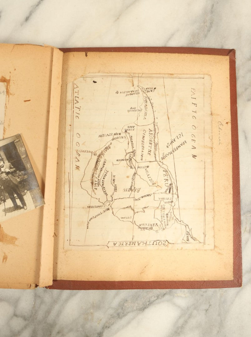 Lot 009 - Short But Interesting Railroad Related Scrapbook With Cabinet Cards And Obituaries Of Conductors, A Hand Drawn Map Of South America, Gravestone Sketch, And More