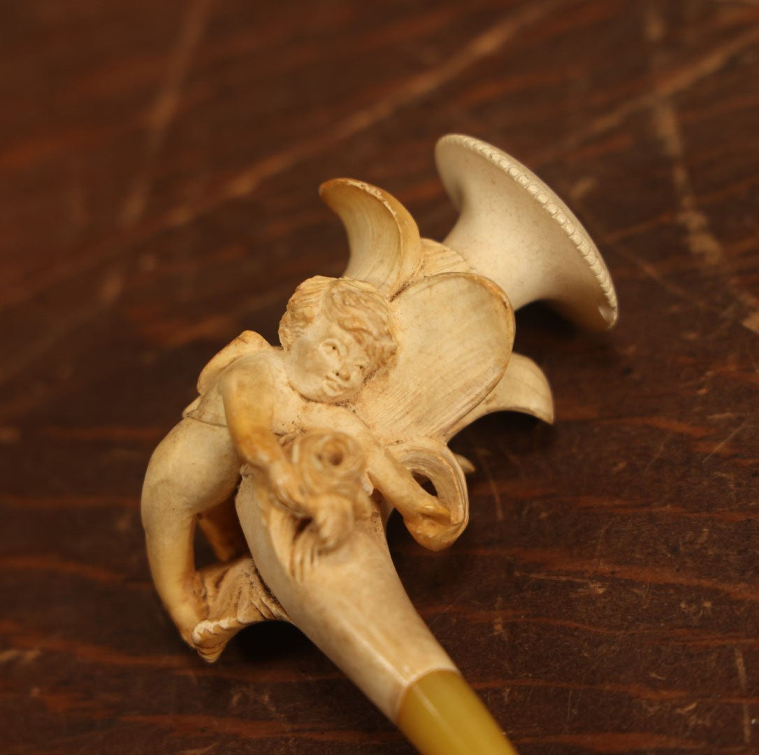 Lot 014 - Antique Genuine Carved Meerschaum Pipe With Cupid Cherub, Yellow Stem, And Original Custom Case. Marked C.P.F. Warranted