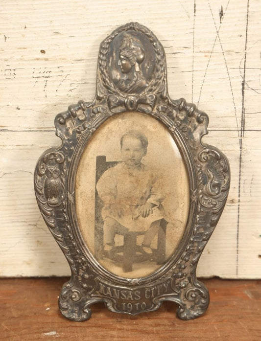 Lot 021 - Antique Tin Frame, Souvenir Of Kansas City, Dated 1910, With Owl And Serpent, Containing A Photo Of A Young Boy Seated In A Chair