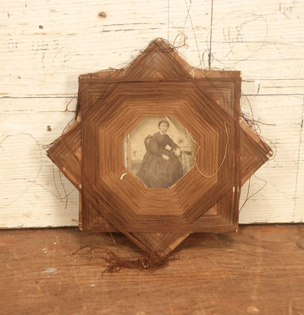 Lot 022 - Antique String Folk Art Frame With C.D.V. Photograph Of A Young Woman Seated In A Chair, Note Some String Unwound