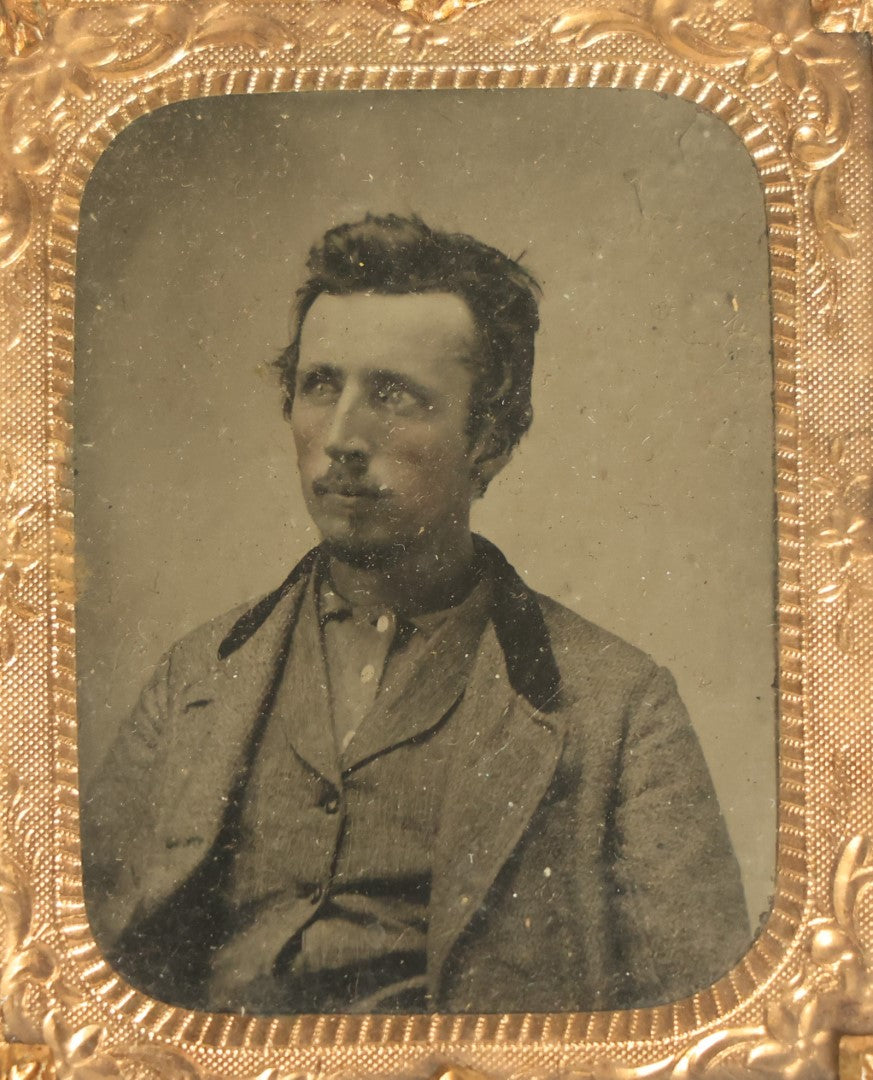 Lot 042 - Antique 1/9th Plate Tintype In Brass Mat Of A Young Man With Slight Facial Hair, Wearing Shirt And Jacket