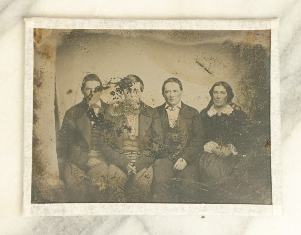 Lot 045 - Craft Grade Approximately 1/4 Plate Ambrotype Of Three Men And A Woman, Note Heavy Wear, Losses, No Frame