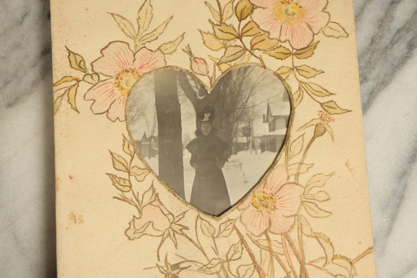 Lot 071 - Antique Hand Painted Paper Frame With Flowers And Leaves, With A Photo Of A Woman On A Street In The Winter, Circa Early 20th Century