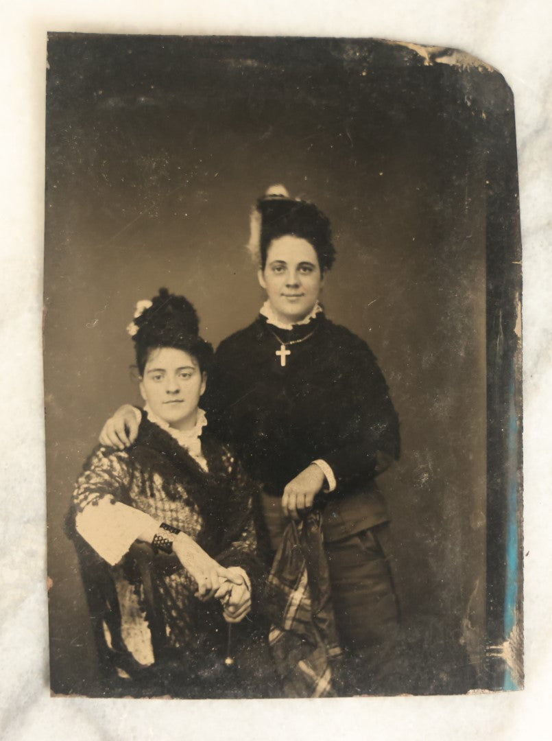 Lot 094 - Single Antique Tintype Photograph, Two Women, One Smiling With Cross, Dark Shirt