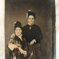Lot 094 - Single Antique Tintype Photograph, Two Women, One Smiling With Cross, Dark Shirt