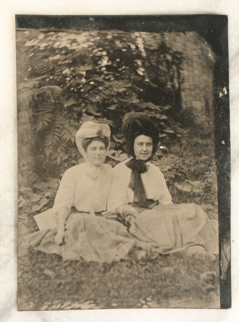 Lot 095 - Single Antique Tintype Photograph, Two Women Outdoors, Sitting On Grass, Smiling