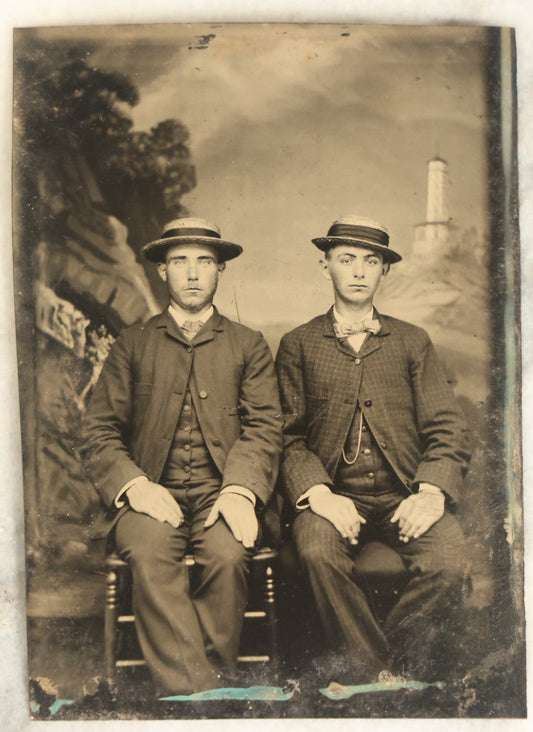 Lot 101 - Single Antique Tintype Photograph, Two Men In Hats, With Backdrop With Tower