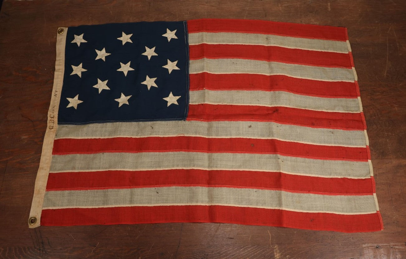 Lot 013 - Antique Hand Sewn United States Thirteen Star Flag, Circa Late 19th Century, Signed G.B. Cook., Note Various Holes And Wear 