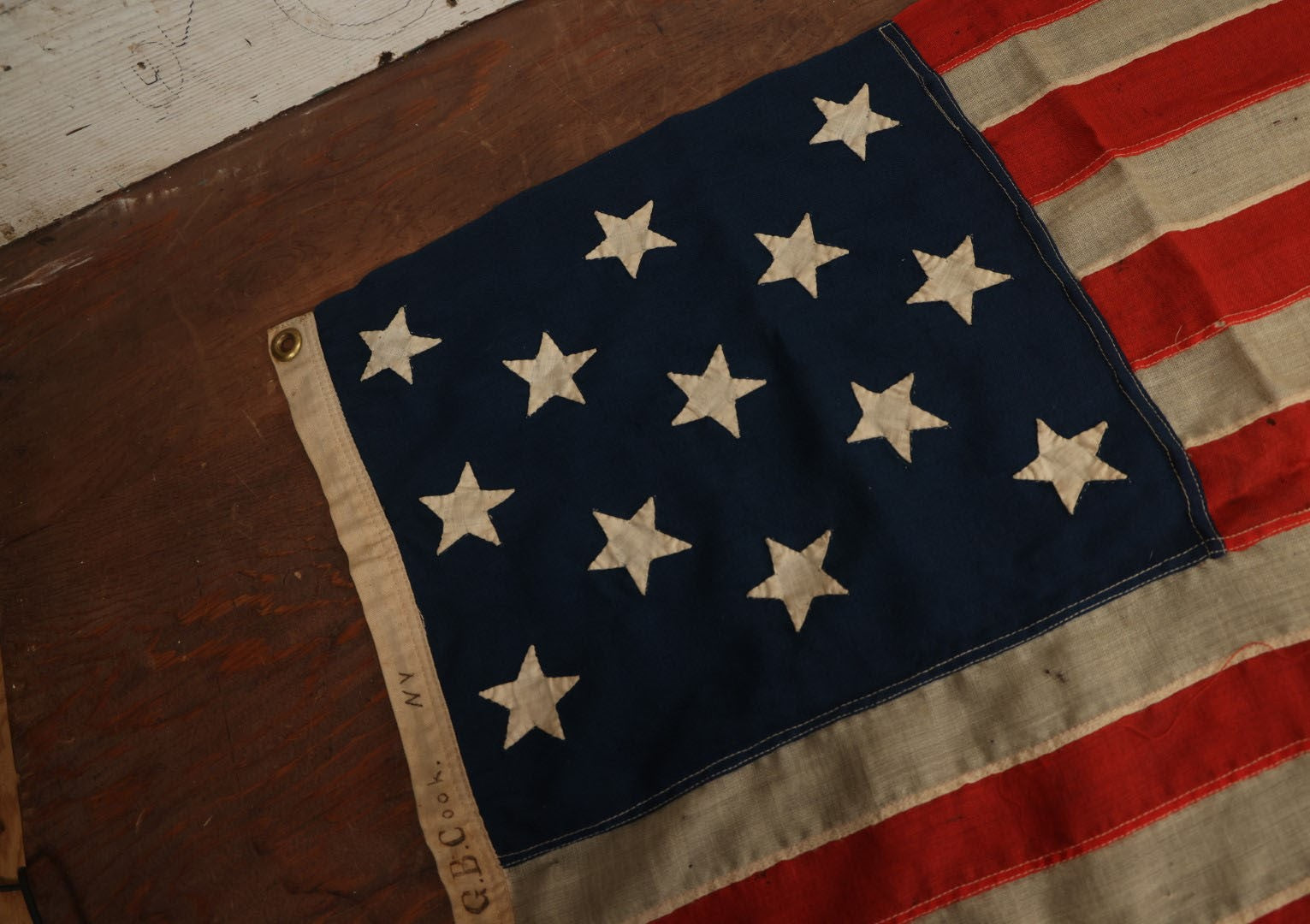 Lot 013 - Antique Hand Sewn United States Thirteen Star Flag, Circa Late 19th Century, Signed G.B. Cook., Note Various Holes And Wear 