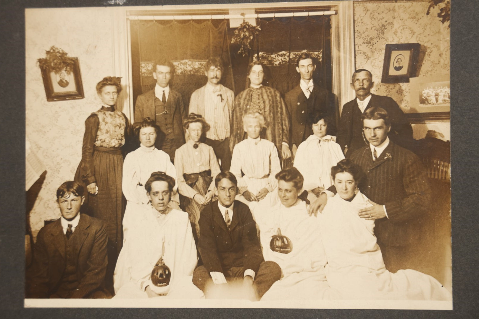 Lot 022 - Antique Turn Of The Century Boarded Photograph Of A Halloween Party, Including Two Women Holding Jack-O-Lantern Pumpkins, Pencil Identification On Back, Approximately 8-7/8" x 7"