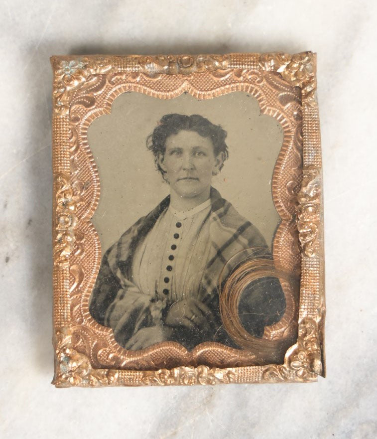 Lot 023 - Antique 1/9th Plate Tintype Of Middle Aged Woman In Mat Behind Glass With Lock Of Hair Memento, Shirt With Black Buttons