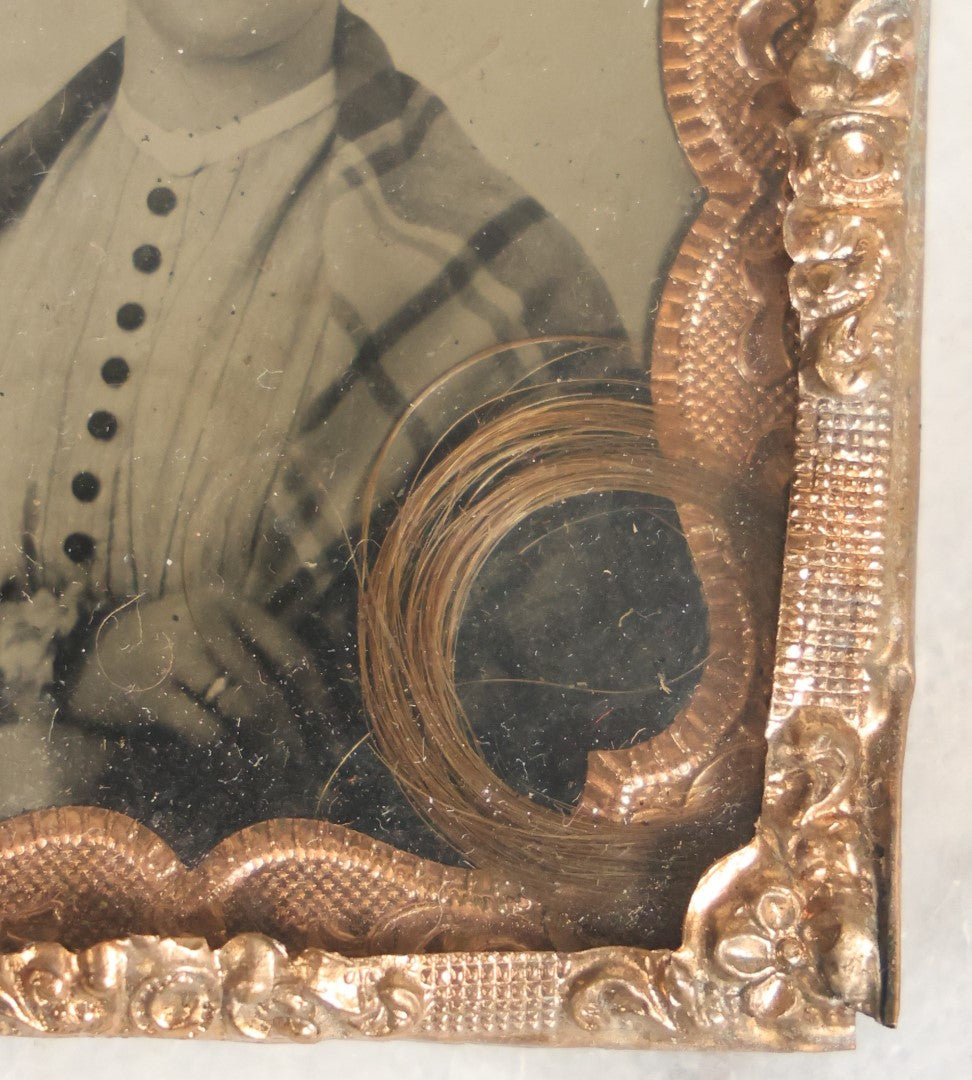 Lot 023 - Antique 1/9th Plate Tintype Of Middle Aged Woman In Mat Behind Glass With Lock Of Hair Memento, Shirt With Black Buttons