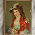 Lot 028 - Antique Victorian Trade Card Scrapbook Album With Woman In Red On Cover, Containing Many Scraps Including Rat Poison, Calling Card, Frogs, And More.