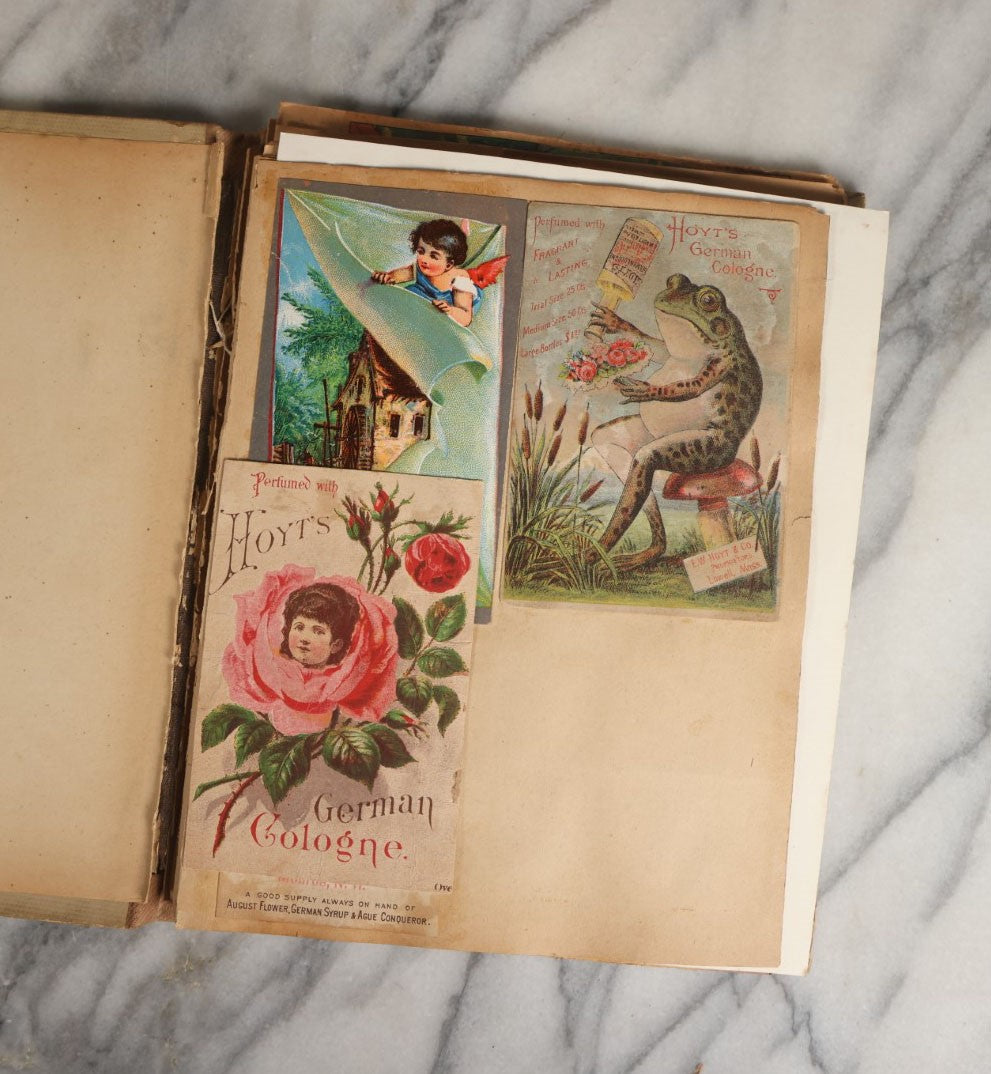 Lot 028 - Antique Victorian Trade Card Scrapbook Album With Woman In Red On Cover, Containing Many Scraps Including Rat Poison, Calling Card, Frogs, And More.