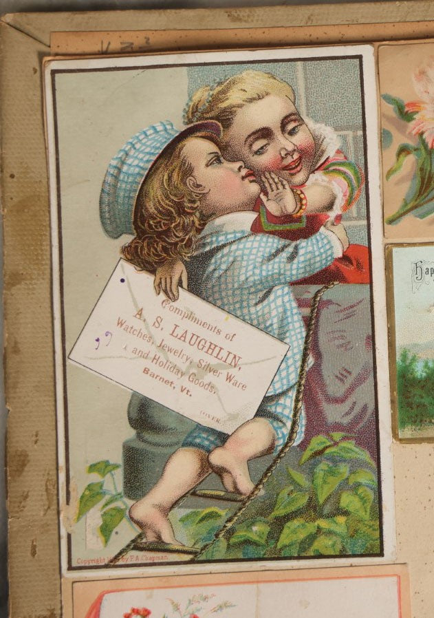 Lot 029 - Antique Victorian Trade Card Scrapbook Album With Two Girls And Puppy On Cover, Containing Many Scraps Including Rat Poison, Calling Card, Frogs, And More