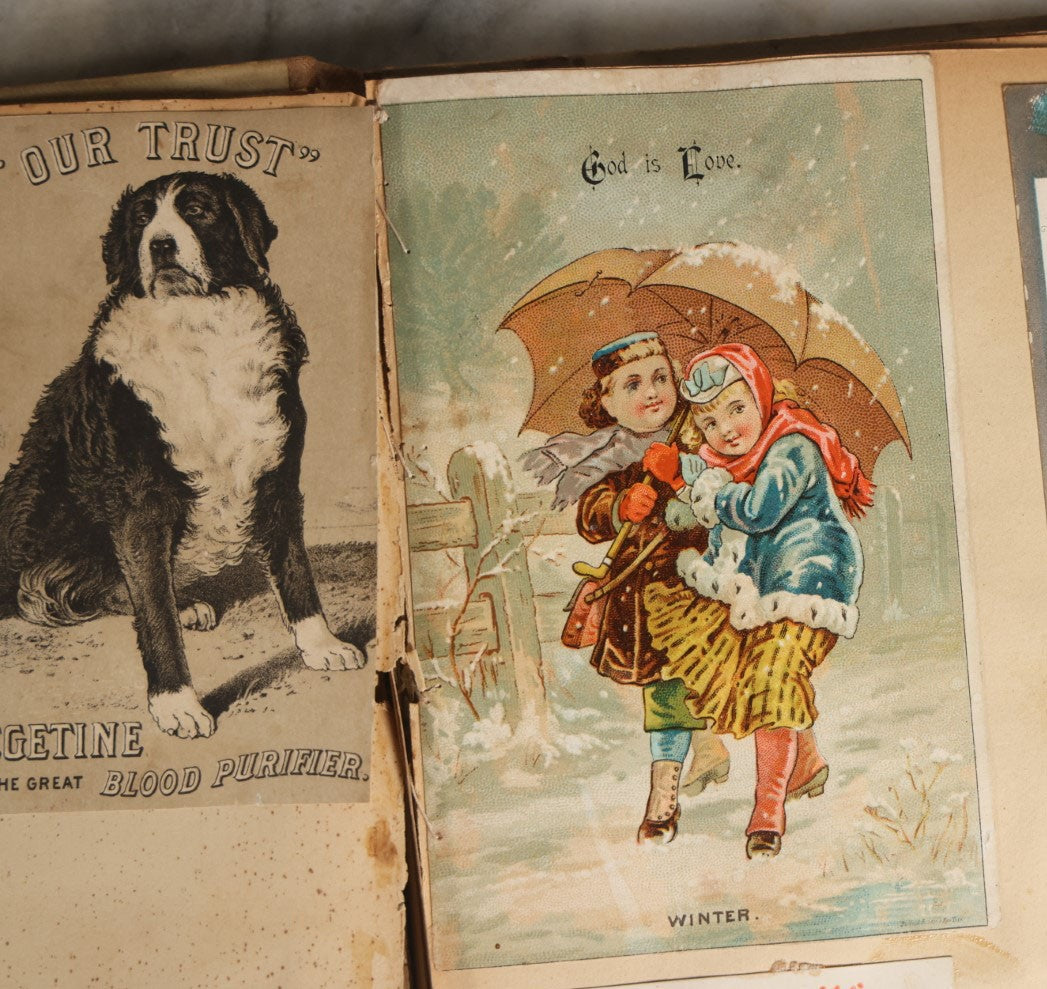 Lot 029 - Antique Victorian Trade Card Scrapbook Album With Two Girls And Puppy On Cover, Containing Many Scraps Including Rat Poison, Calling Card, Frogs, And More