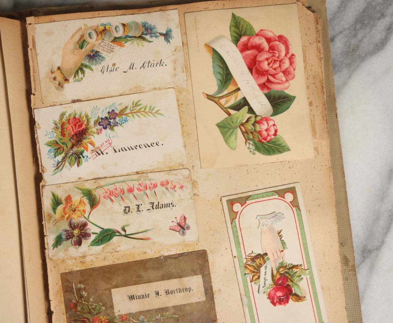 Lot 029 - Antique Victorian Trade Card Scrapbook Album With Two Girls And Puppy On Cover, Containing Many Scraps Including Rat Poison, Calling Card, Frogs, And More