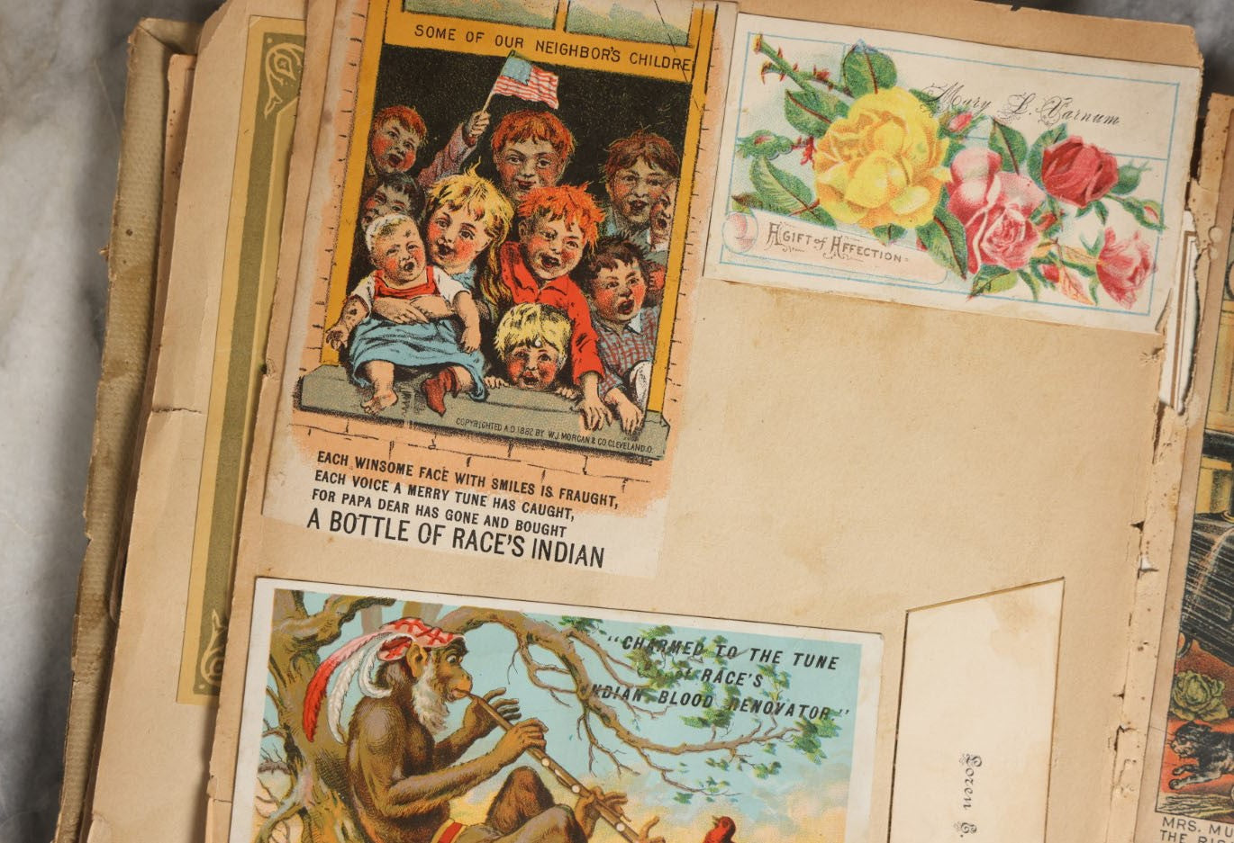 Lot 029 - Antique Victorian Trade Card Scrapbook Album With Two Girls And Puppy On Cover, Containing Many Scraps Including Rat Poison, Calling Card, Frogs, And More