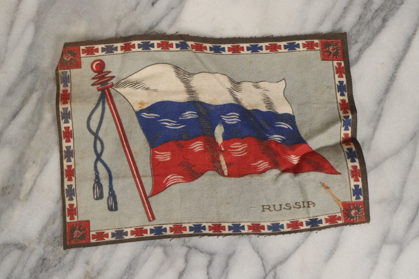 Lot 039 - Grouping Of Ten Antique Tobacco Felt Flags, Including Japan, 2 x Russia, Italy, Mexico, Cuba, Belgium, Netherlands, Austria-Hungary, And The Union Jack, Various Wear.