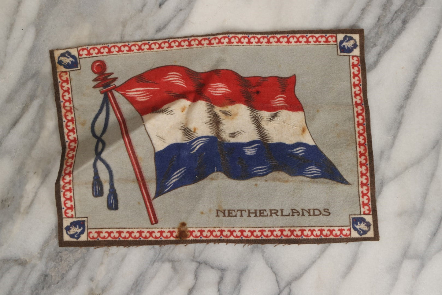 Lot 039 - Grouping Of Ten Antique Tobacco Felt Flags, Including Japan, 2 x Russia, Italy, Mexico, Cuba, Belgium, Netherlands, Austria-Hungary, And The Union Jack, Various Wear.