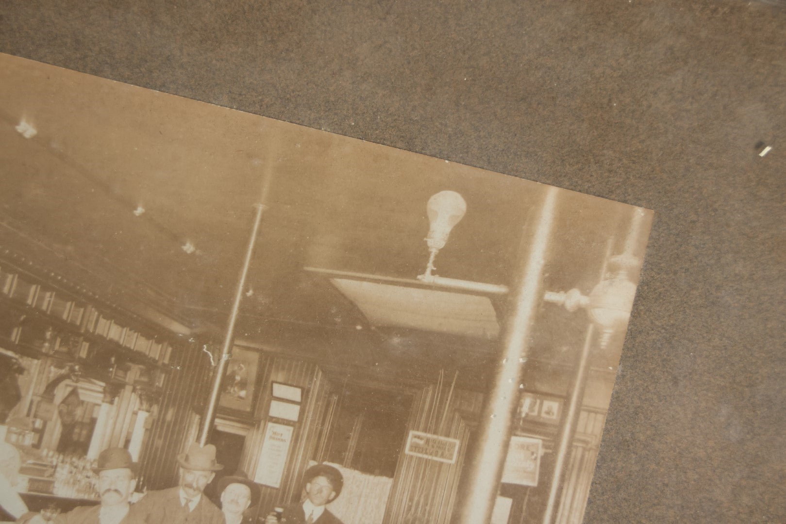 Lot 050 - Antique Framed Boarded Photograph Of A Bar Room, Four Men At The Bar With Barkeeper, Beer Advertisements, Etc