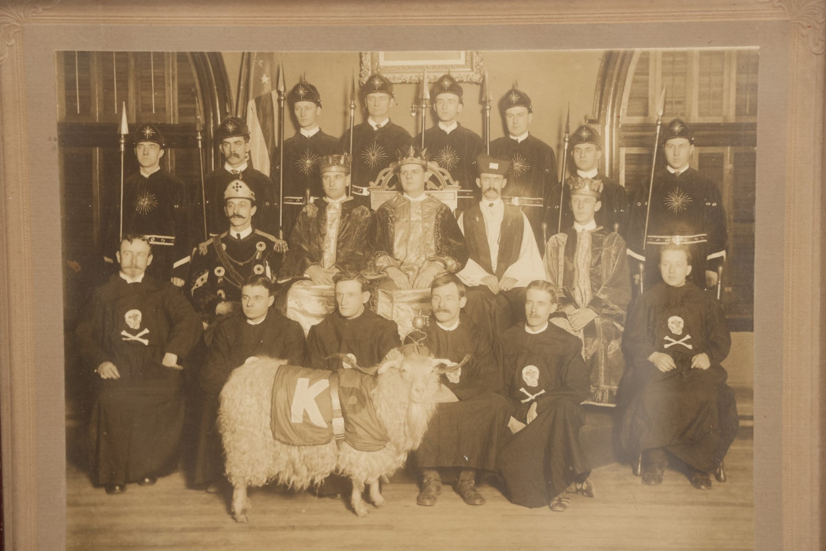 Lot 020 - Antique Boarded Group Photo, Fraternal Gathering, Likely Knights Of Pythias, With Goat And Skull And Crossbones Scene Bearers Robes, In Frame, 11-1/4" x 9-1/4"